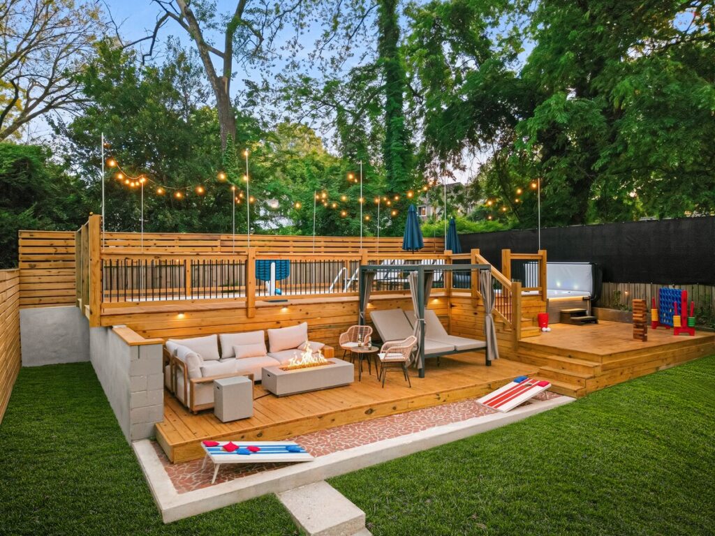 Game Room at Luxury 5BR Oasis in Atlanta, GA – private backyard oasis featuring multiple lounge zones, string lights, outdoor seating