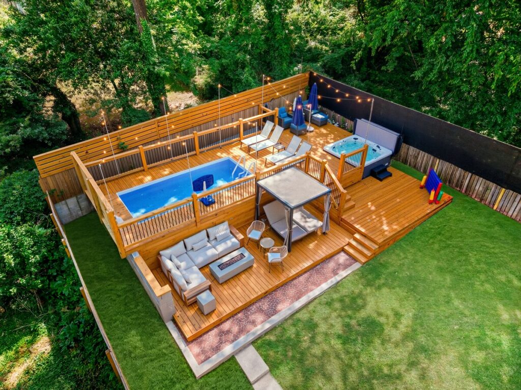 Multi-level backyard with pool, spa and fire pit at Luxury 5BR Oasis, one of our Atlanta vacation rentals for groups