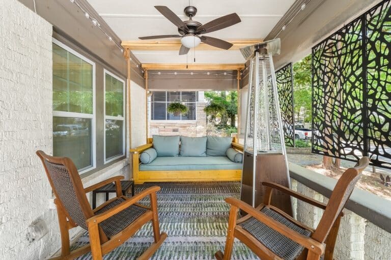 Playground at Luxury 5BR Oasis in Atlanta, GA – covered front porch with a hanging rope swing bed, rocking chairs, ceiling fan and patio